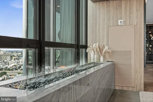 a bathroom with a large window and a bed