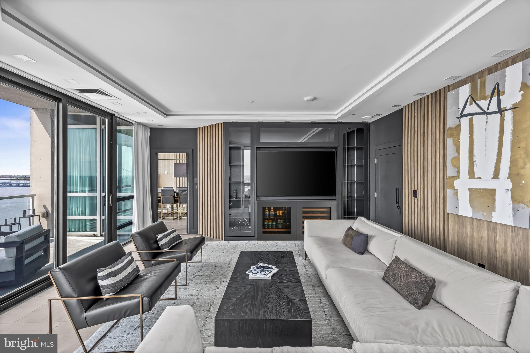 901 North Penn Street, Unit P24012 Philadelphia, PA 19123 - Photo 23 of 59 a living room with furniture a large window and a flat screen tv