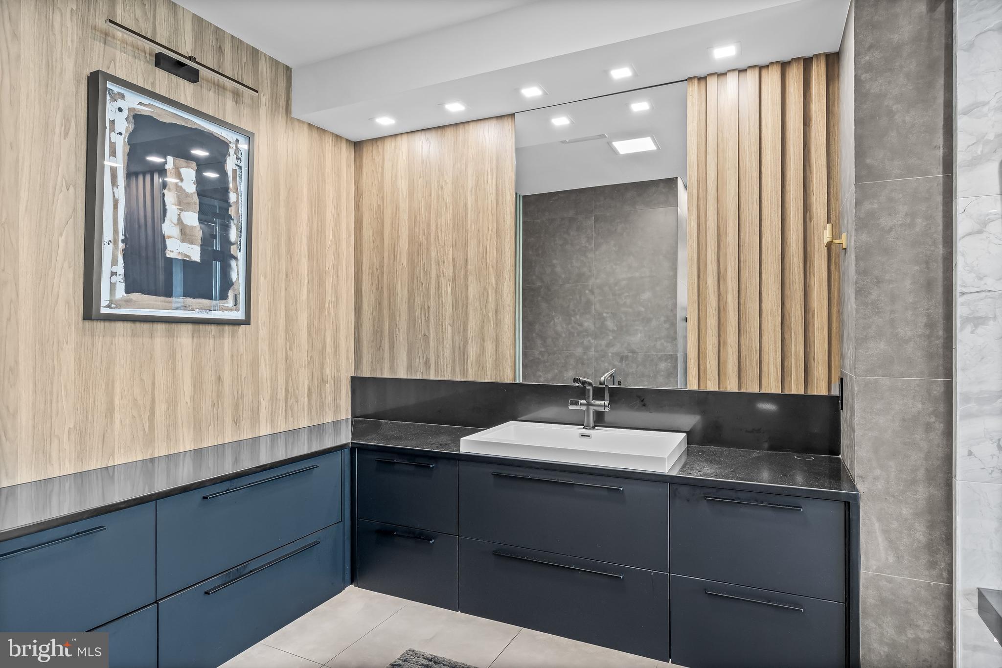 901 North Penn Street, Unit P24012 Philadelphia, PA 19123 - Photo 31 of 59 a bathroom with a double vanity sink and a mirror