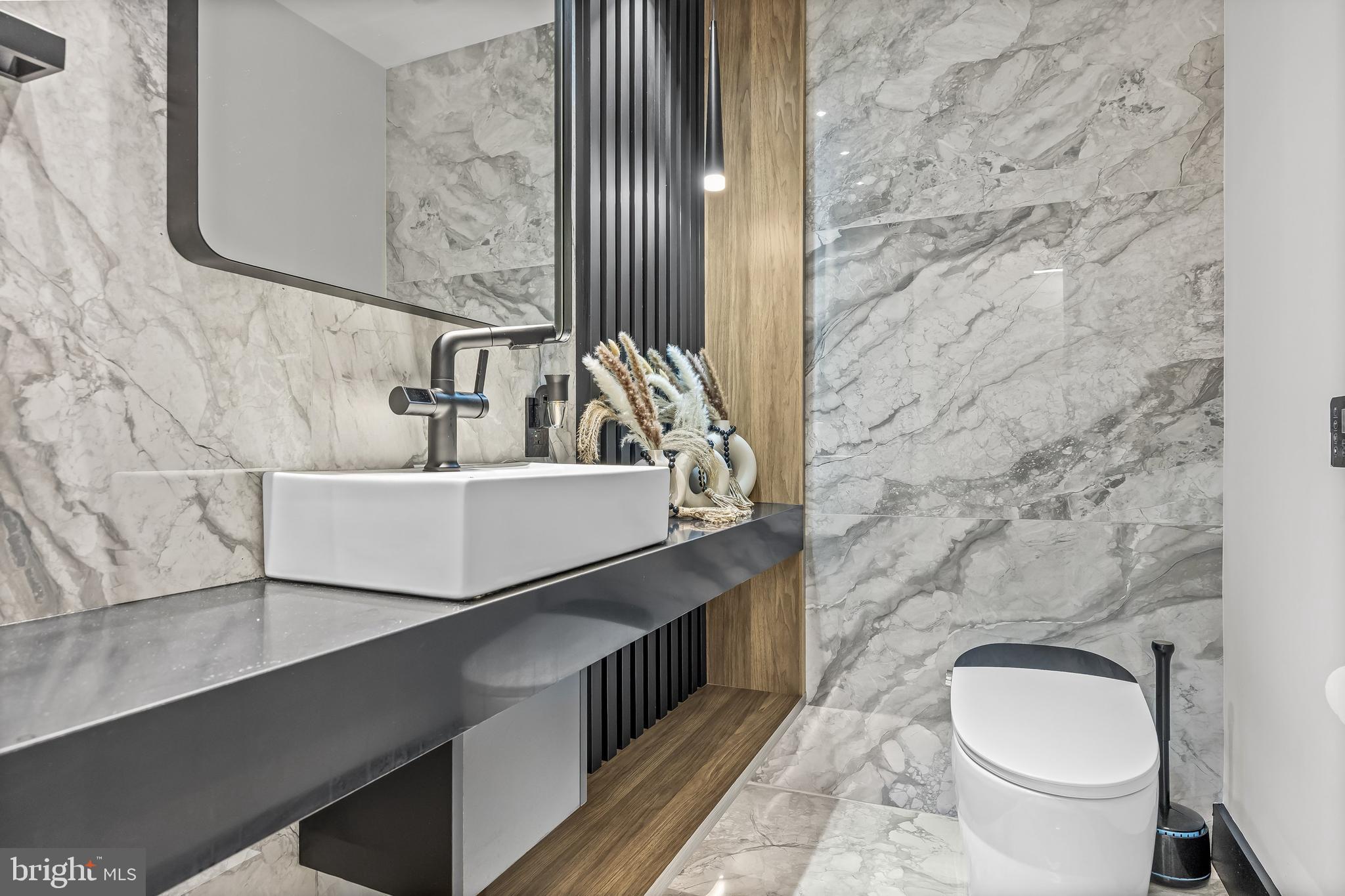 901 North Penn Street, Unit P24012 Philadelphia, PA 19123 - Photo 36 of 59 a bathroom with a sink a toilet and mirror