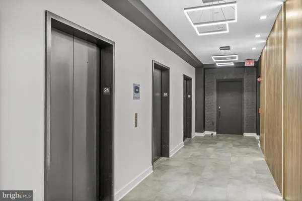 a view of a hallway with two mirrors and door