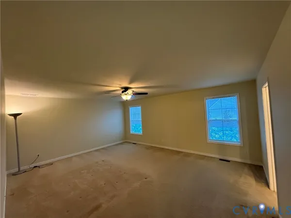 an empty room with windows and closet