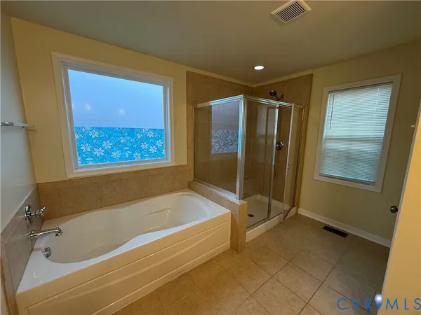 a bathroom with a tub and a shower