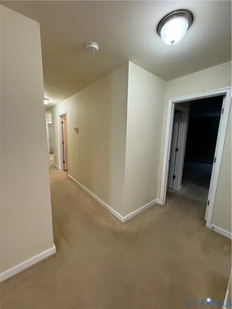 an empty room with closet and mirror