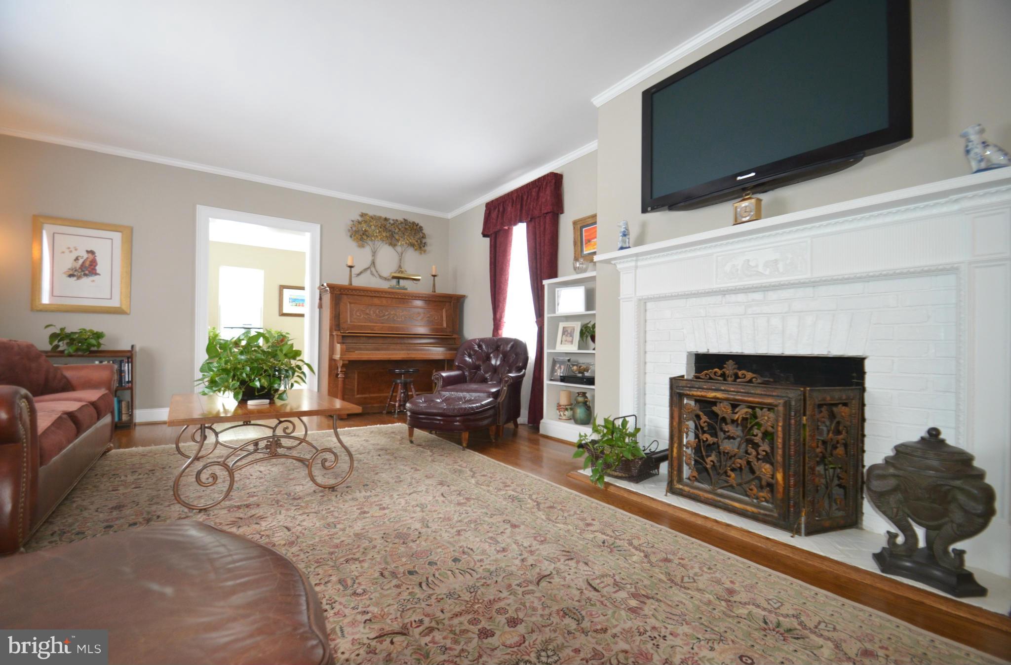 307 East Highfield Road Baltimore, MD 21218 - Photo 11 of 30 a living room with furniture a flat screen tv and a fireplace