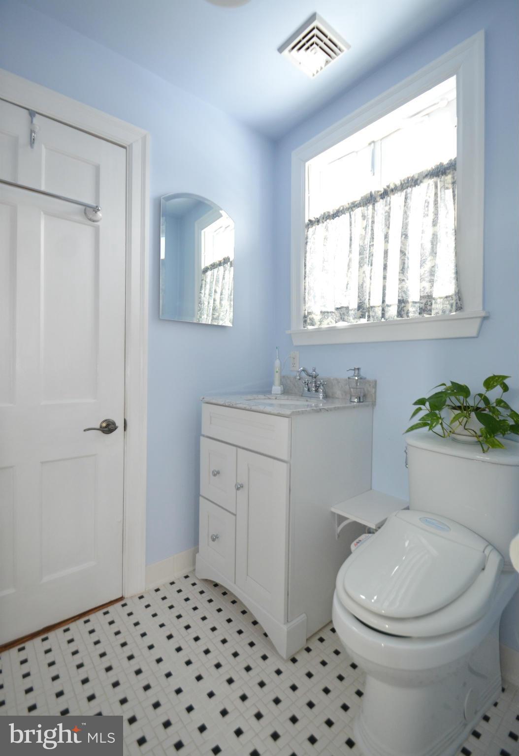 307 East Highfield Road Baltimore, MD 21218 - Photo 20 of 30 a bathroom with a sink a toilet and window