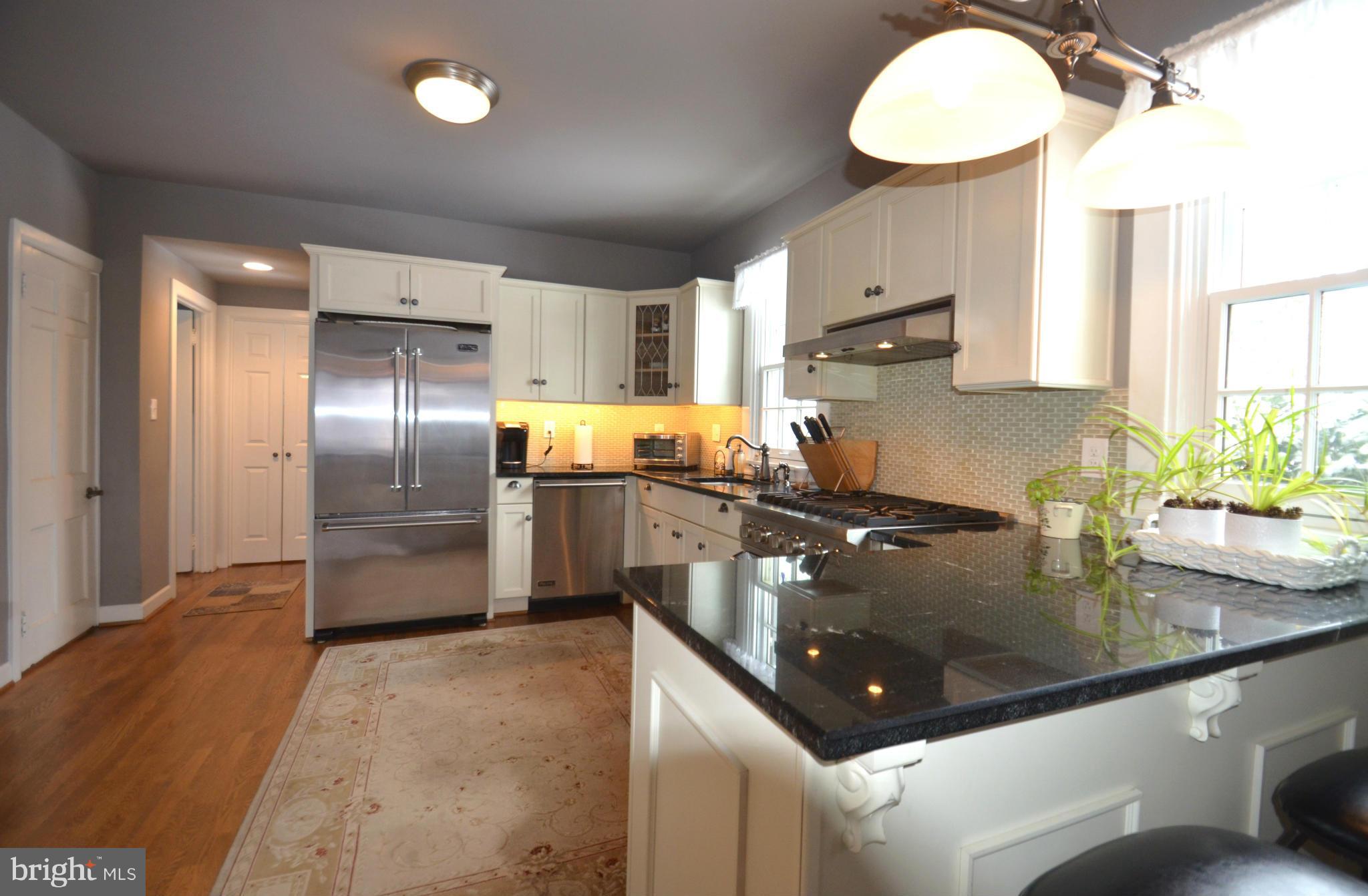 307 East Highfield Road Baltimore, MD 21218 - Photo 3 of 30 a kitchen with stainless steel appliances granite countertop a sink a stove and a refrigerator