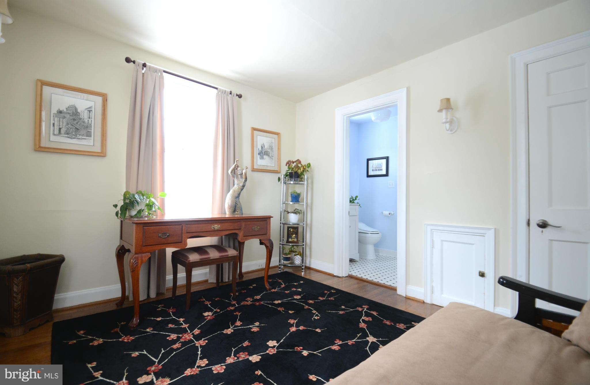 307 East Highfield Road Baltimore, MD 21218 - Photo 22 of 30 a bedroom with a bed and wooden floor