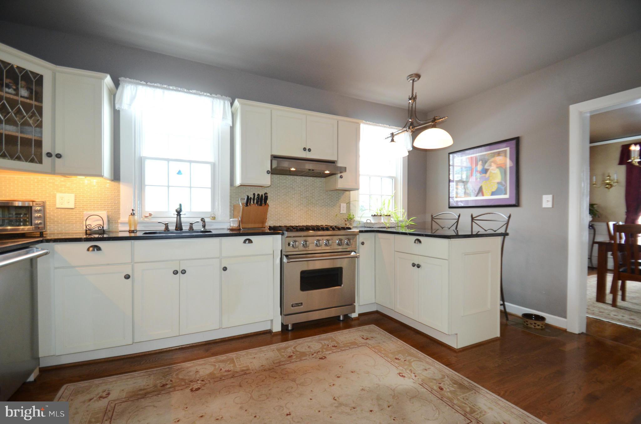 307 East Highfield Road Baltimore, MD 21218 - Photo 4 of 30 a kitchen with granite countertop white cabinets and white appliances