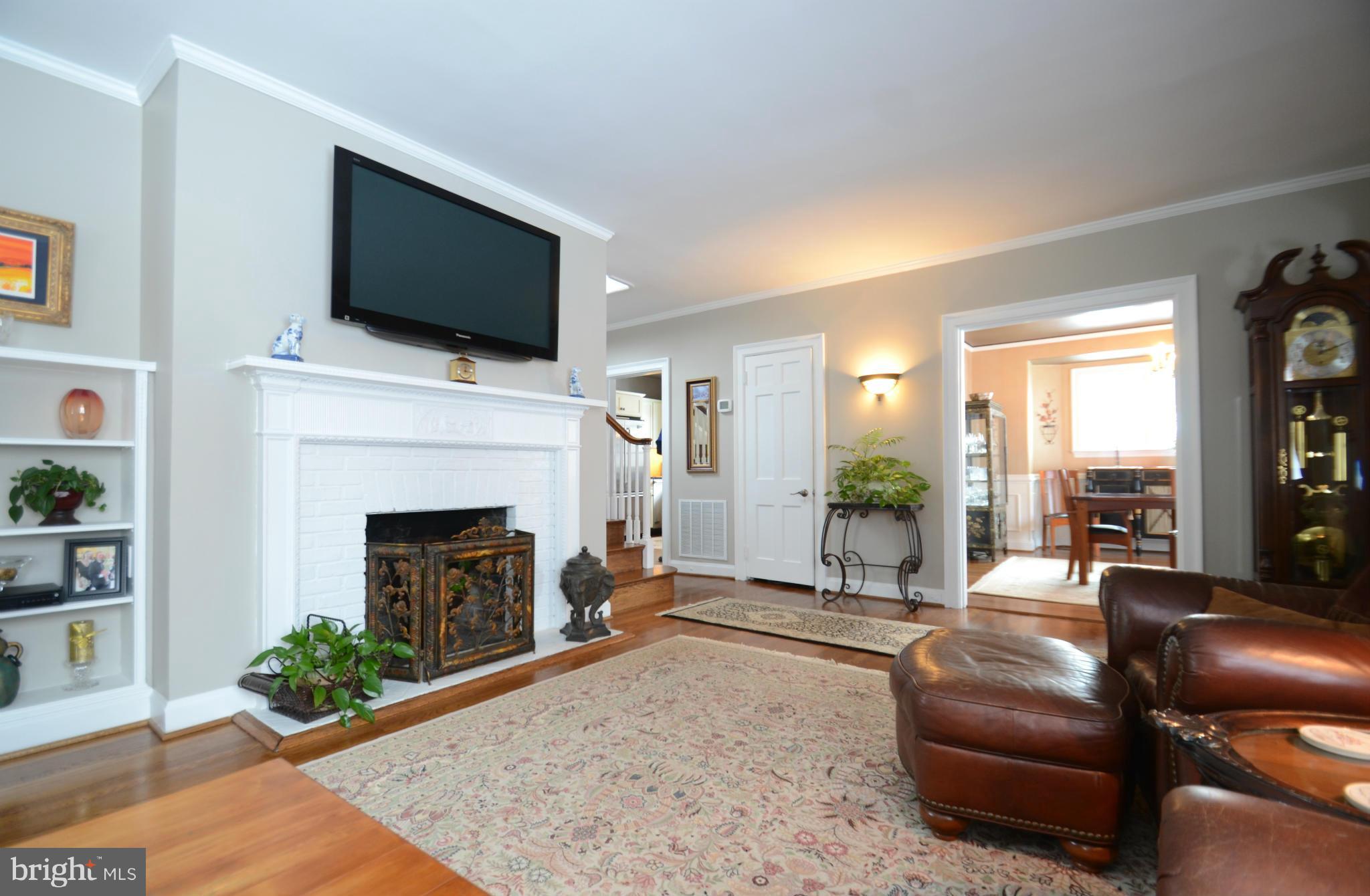 307 East Highfield Road Baltimore, MD 21218 - Photo 9 of 30 a living room with furniture a flat screen tv and a fireplace