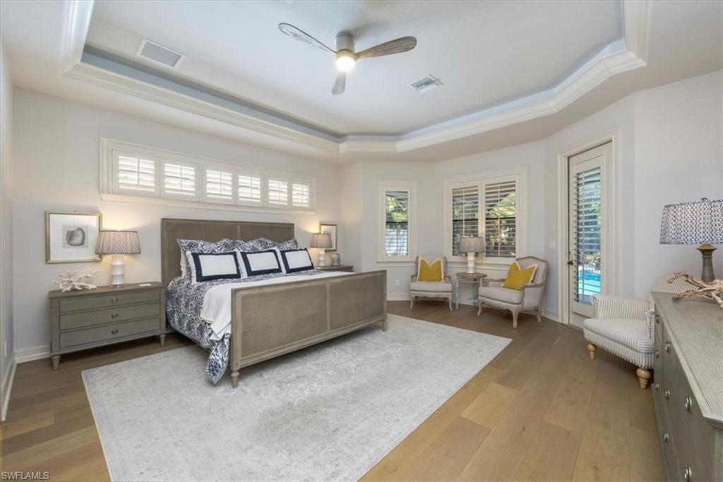 7263 Acorn Way Naples, FL 34119 - Photo 12 of 34 a bedroom with a bed and furniture