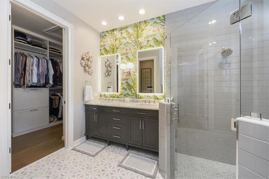7263 Acorn Way Naples, FL 34119 - Photo 16 of 34 a bathroom with a sink and a mirror