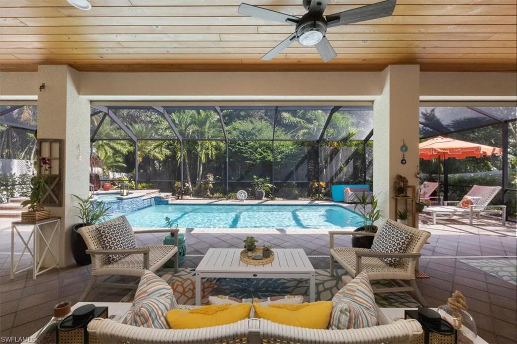 7263 Acorn Way Naples, FL 34119 - Photo 17 of 34 a outdoor living space with furniture and a fireplace