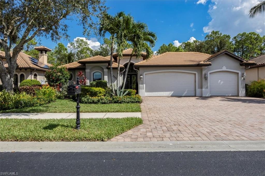 7263 Acorn Way Naples, FL 34119 - Photo 2 of 34 a front view of a house with a yard and a garage