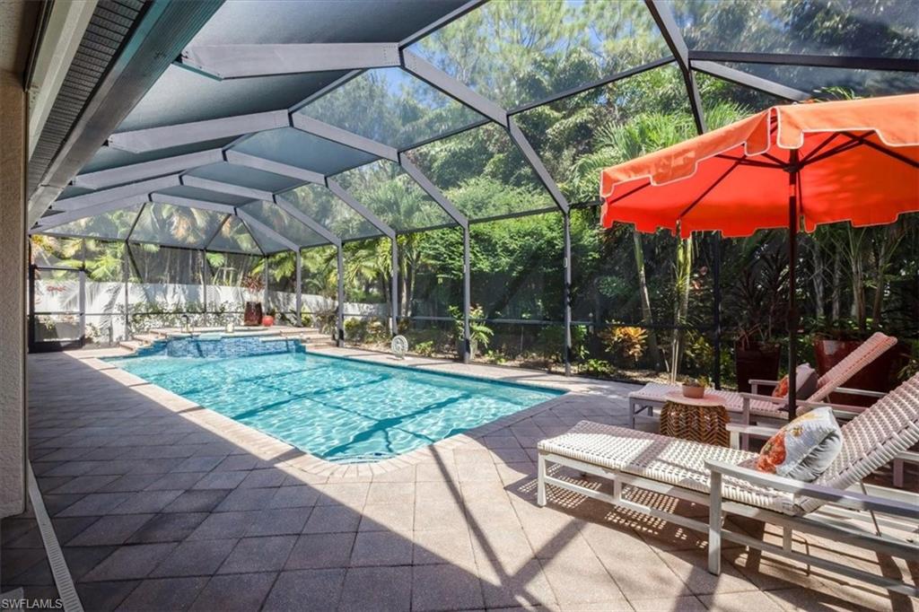 7263 Acorn Way Naples, FL 34119 - Photo 22 of 34 a view of patio with a table and chairs under an umbrella