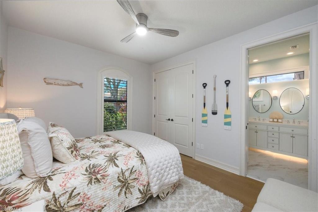 7263 Acorn Way Naples, FL 34119 - Photo 27 of 34 a bedroom with a bed and a mirror