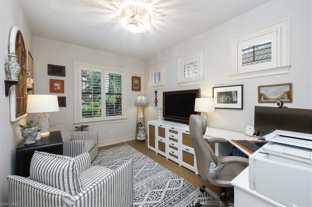 7263 Acorn Way Naples, FL 34119 - Photo 31 of 34 a bedroom with furniture and a flat screen tv