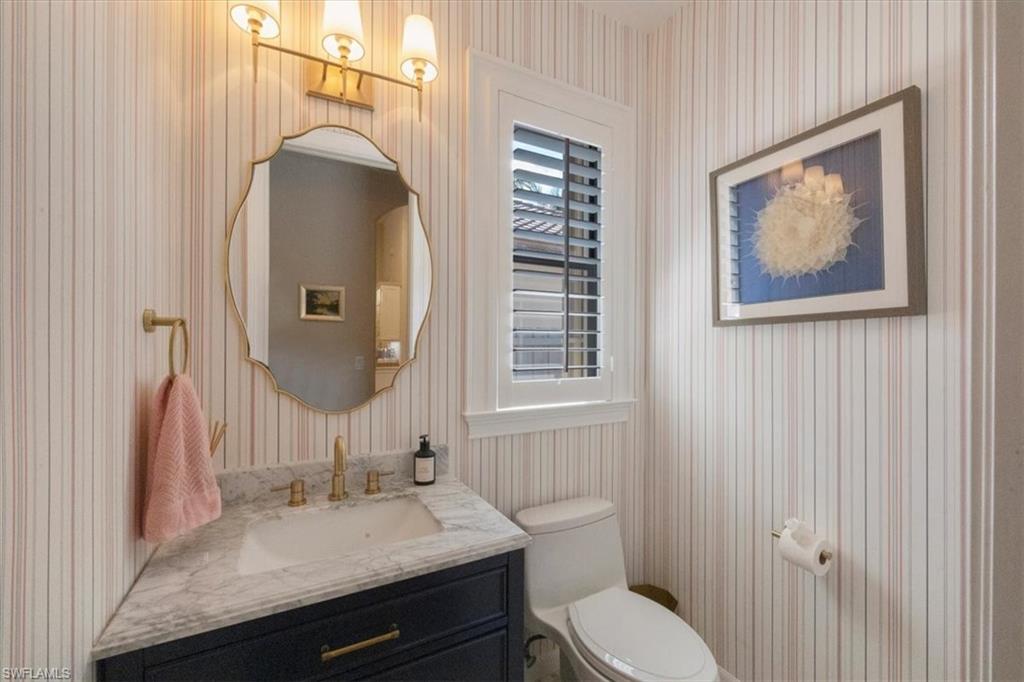 7263 Acorn Way Naples, FL 34119 - Photo 33 of 34 a bathroom with a granite countertop sink and a mirror