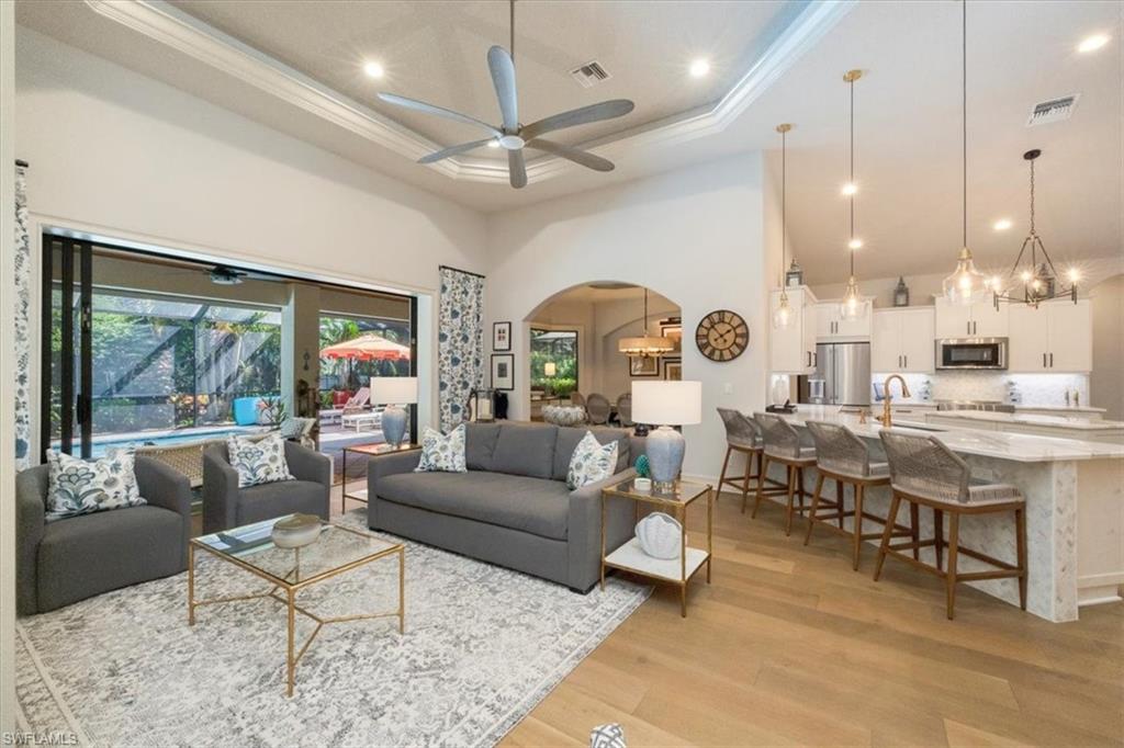 7263 Acorn Way Naples, FL 34119 - Photo 4 of 34 a living room with lots of furniture and a large window