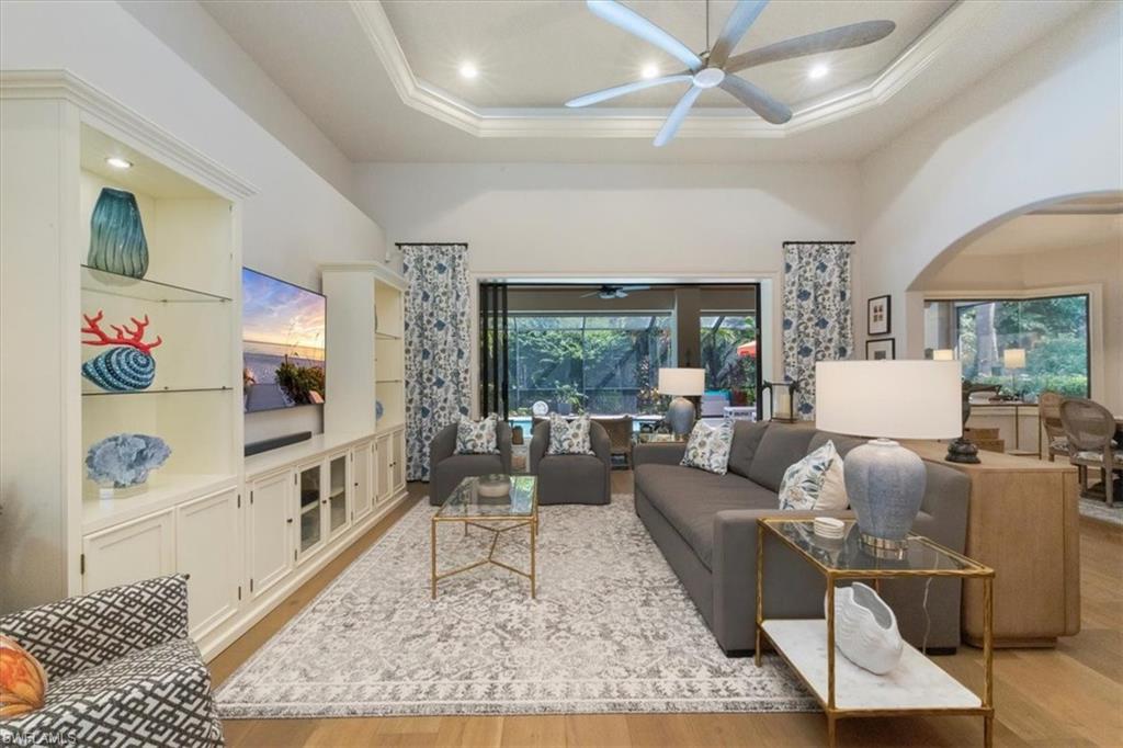 7263 Acorn Way Naples, FL 34119 - Photo 5 of 34 a living room with furniture and a flat screen tv