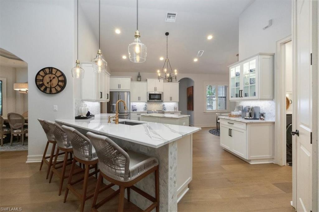 7263 Acorn Way Naples, FL 34119 - Photo 6 of 34 a large kitchen with a table and chairs