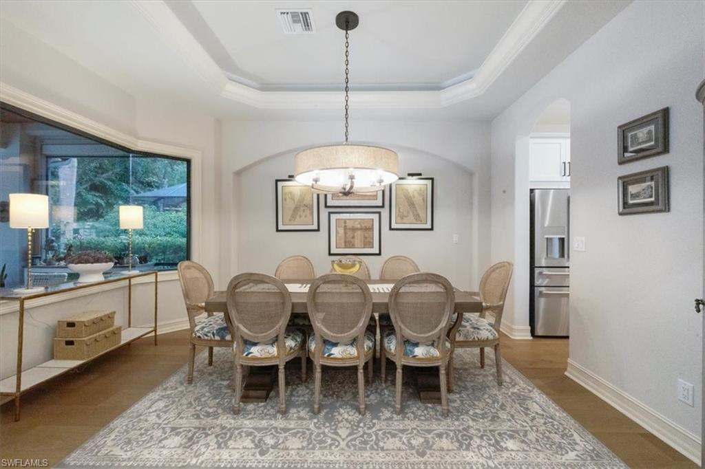 7263 Acorn Way Naples, FL 34119 - Photo 10 of 34 a view of a dining room with furniture window and wooden floor
