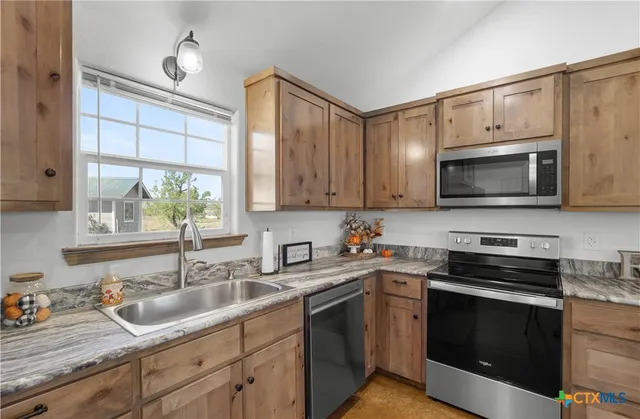 a kitchen with a sink stove and microwave