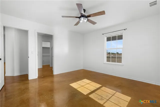 a bathroom with a granite countertop shower and a toilet