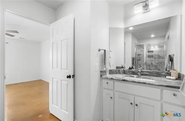 a bathroom with a glass shower door
