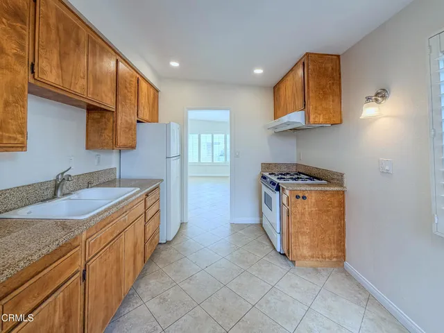 a kitchen with stainless steel appliances a refrigerator sink and cabinets