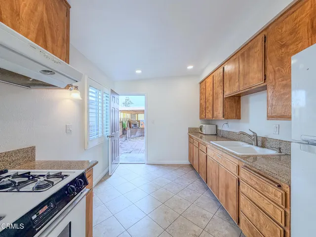 a kitchen with granite countertop a stove and a sink