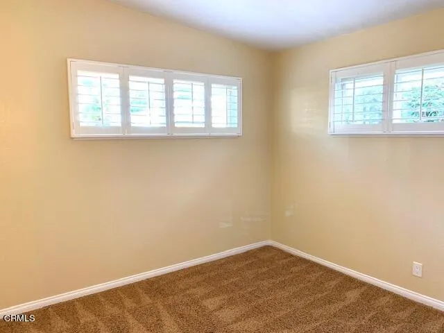a view of a room with cabinet and mirrors