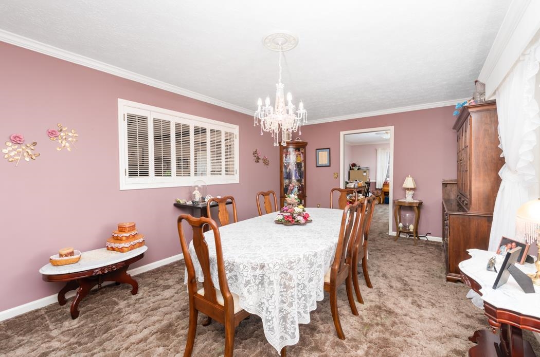 198 Baynes Road Waynesboro, VA 22980 - Photo 31 of 74 a dining room with furniture a chandelier and wooden floor