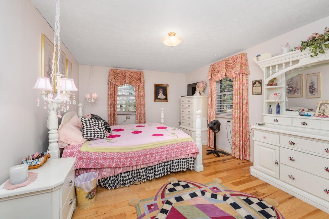 198 Baynes Road Waynesboro, VA 22980 - Photo 33 of 74 a bedroom with a bed and wooden floor