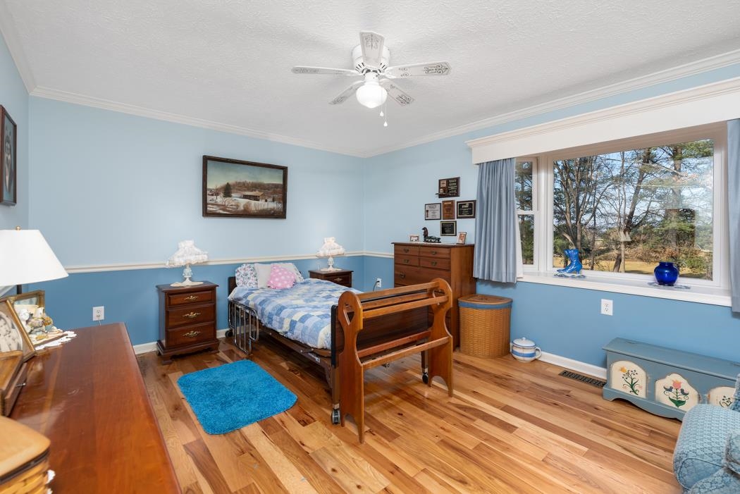 198 Baynes Road Waynesboro, VA 22980 - Photo 37 of 74 a bedroom with a bed and wooden floor