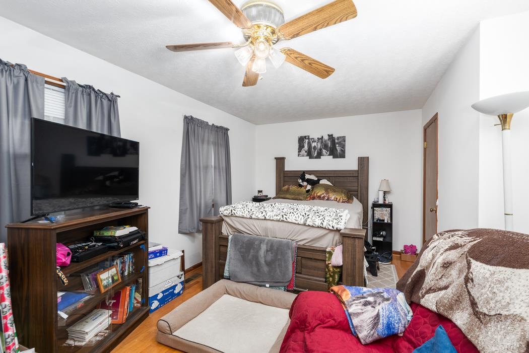 198 Baynes Road Waynesboro, VA 22980 - Photo 73 of 74 a bedroom with a bed a flat screen tv and a chandelier