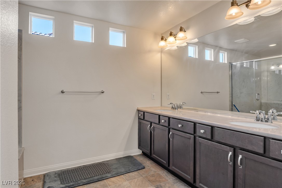 10073 Icicle Ridge Las Vegas, NV 89141 - Photo 11 of 23 Full bathroom with double vanity and a stall shower
