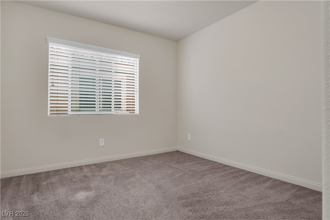 10073 Icicle Ridge Las Vegas, NV 89141 - Photo 14 of 23 Carpeted spare room featuring baseboards