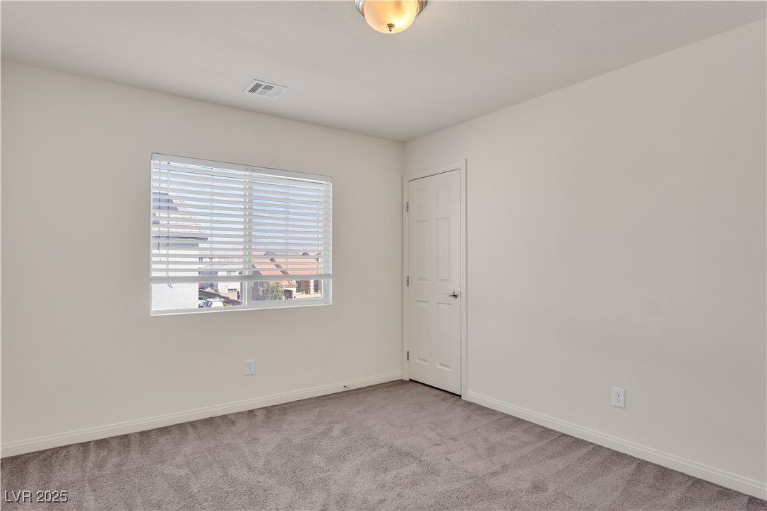 10073 Icicle Ridge Las Vegas, NV 89141 - Photo 21 of 23 Unfurnished room featuring baseboards and carpet floors