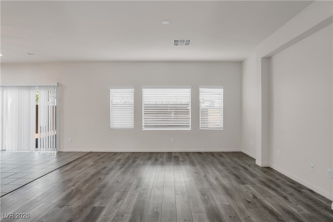 10073 Icicle Ridge Las Vegas, NV 89141 - Photo 5 of 23 Spare room featuring wood finished floors and baseboards