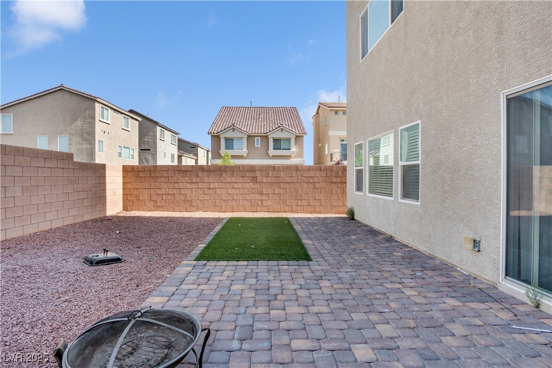 10073 Icicle Ridge Las Vegas, NV 89141 - Photo 8 of 23 Fenced backyard featuring a patio and a residential view