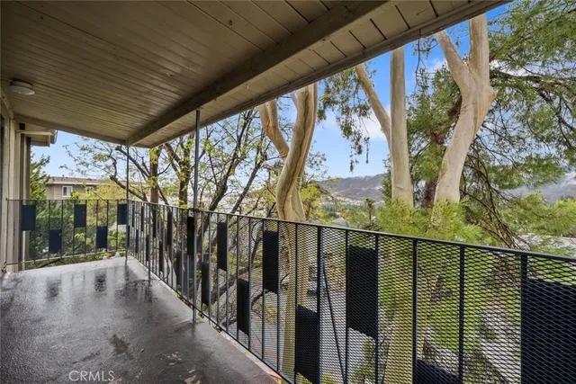 a view of balcony with wooden floor