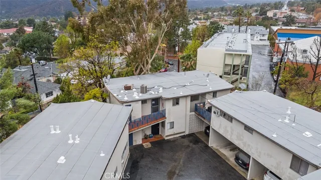 an aerial view of a house with a yard and balcony