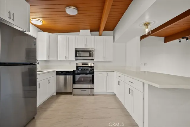 a kitchen with stainless steel appliances and white cabinets