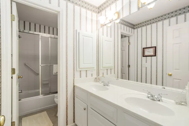 a bathroom with a shower sink and mirror