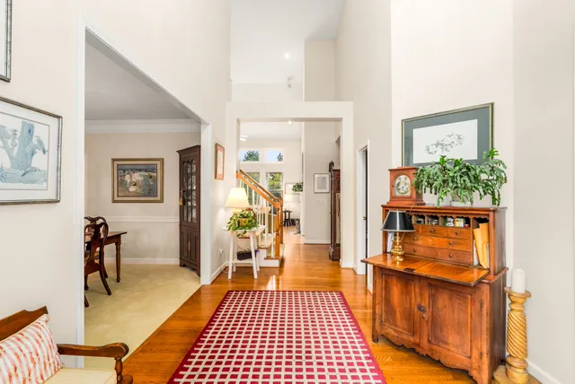 a hallway with a dining table and chairs