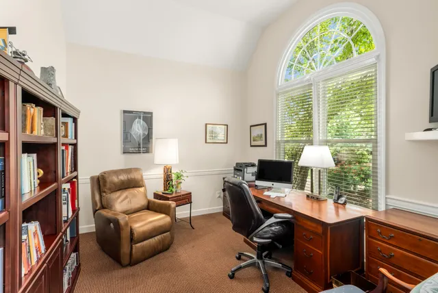 a view of a livingroom with workspace and a window