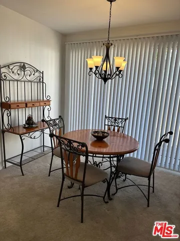 a kitchen with a refrigerator and cabinets