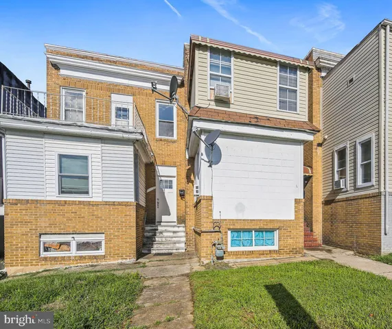 a view of a house with a small yard and a large window