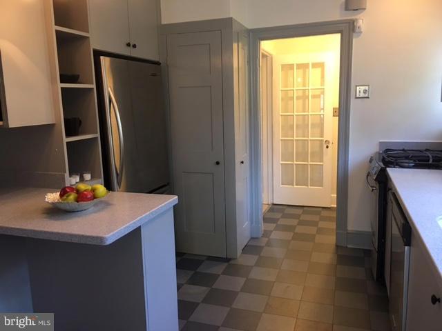 4419 Underwood Road Baltimore, MD 21218 - Photo 12 of 30 a kitchen with a sink a refrigerator and a stove